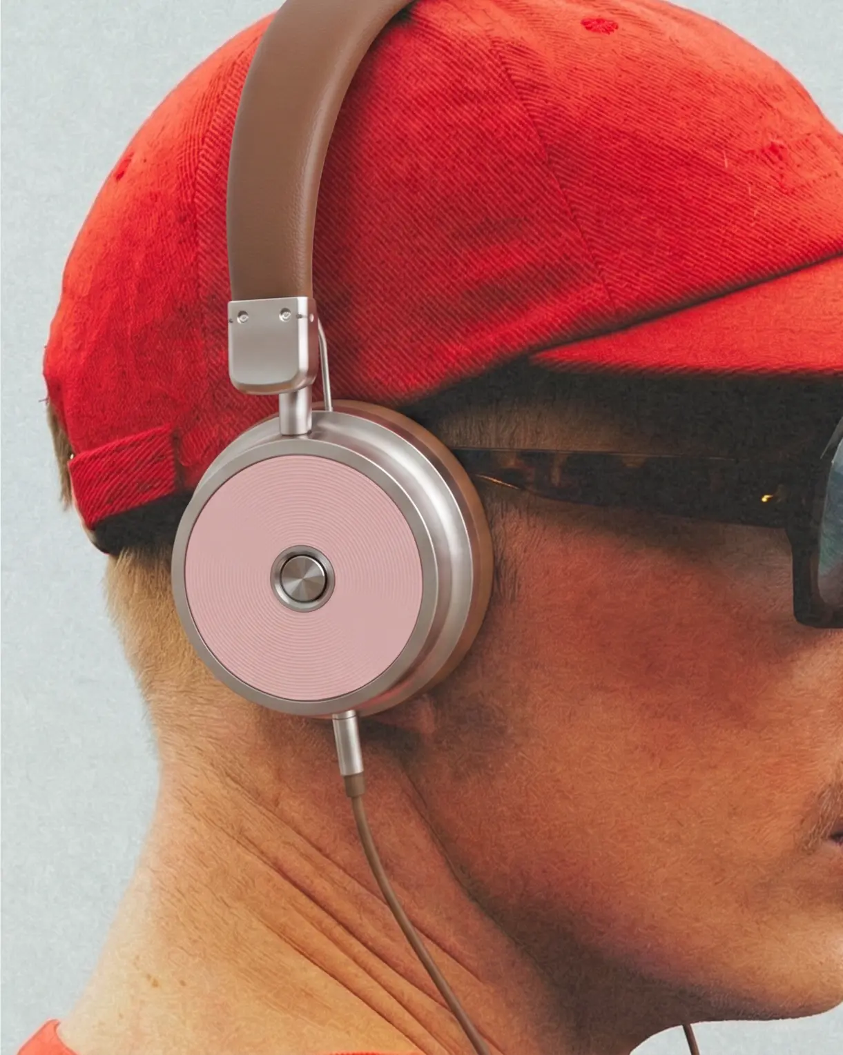 Person in a red cap wearing pink headphones